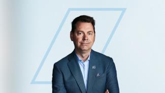 Person posing for a photo with their arms crossed